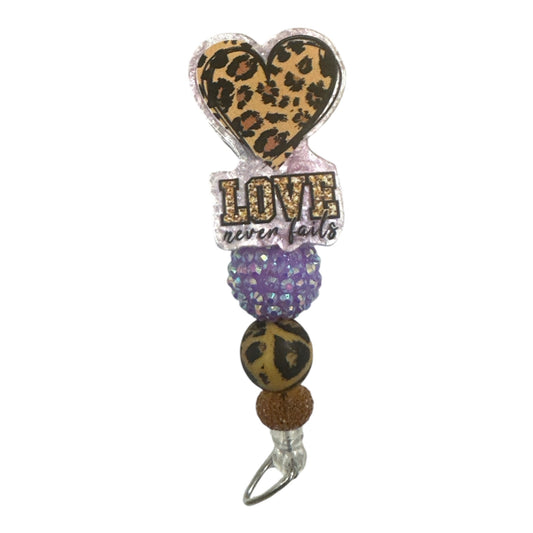 Love Never Fails badge reel